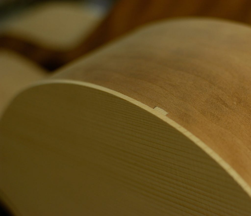 X-brace end mortised through the sides of the orchestra prototype; Adirondack spruce top