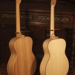 The guitar on the left is built with palo escrito, the other is red maple.