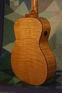 Orchestra guitar no 14 uses red maple sides and back.