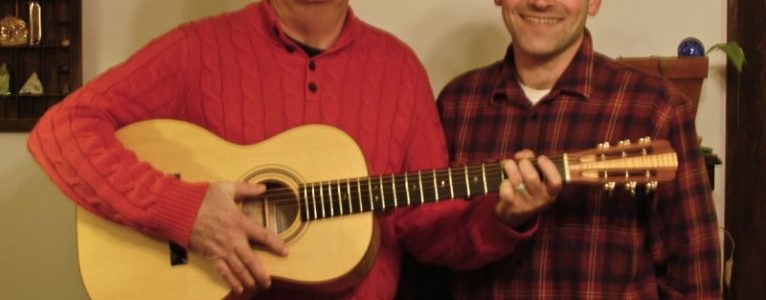 The buyer of no. 3 (left) and I pose with the guitar.
