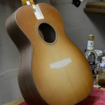 The first coat of shellac is applied over a sunburst dye job