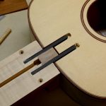 These carbon fiber struts will support the end of the fingerboard.