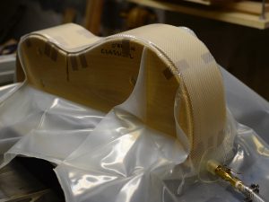 Guitar sides being clamped together in a vacuum press bag.