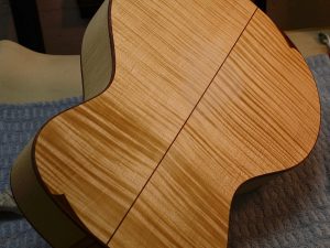 The body gets a wash coat of dye to raise the grain. The body is sanded lightly then another wash coat is applied.