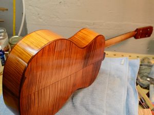 Dye creates a kinetic effect in the way that the light reflecting off the figure is affected by the angle you're seeing the wood from.