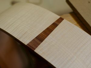 I like to install end wedges with the grain running the same direction as the sides. It looks better to me.