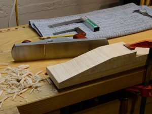 Working the neck scarf joint surfaces down with a smoothing plane.