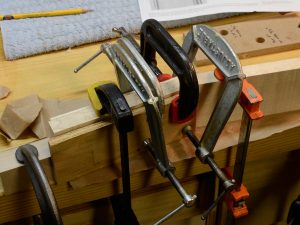 Gluing the neck scarf joint up. That's a lot of clamps, but they aren't gorilla-tight, I just like to spread the clamping pressure out.