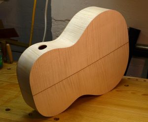 View of the maple back and sides. The opening in the side is a sound port.