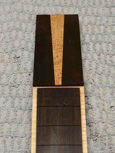 The head plate is glued on and the fingerboard is pinned in place.