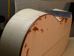 A sharp scraper is the tool of choice for cleaning up bindings.