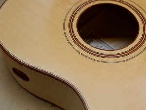 This dark binding used with violin purfling is crisp and elegant.