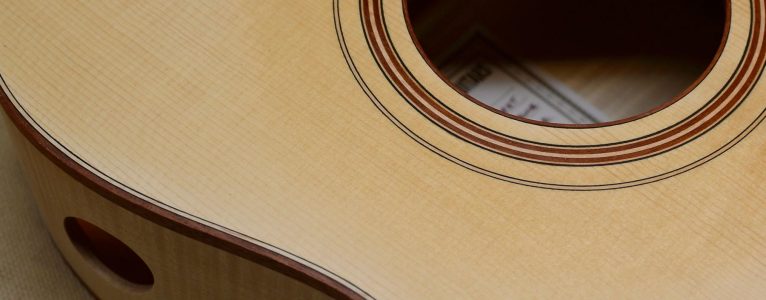 This dark binding used with violin purfling is crisp and elegant.