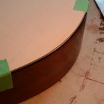 A new guitar top is affixed to an old guitar body