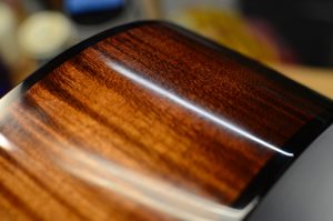 The side of a maple guitar with sunburst color applied, close-up