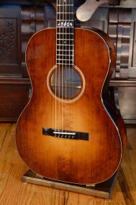 The Adirondack spruce top of a small guitar.